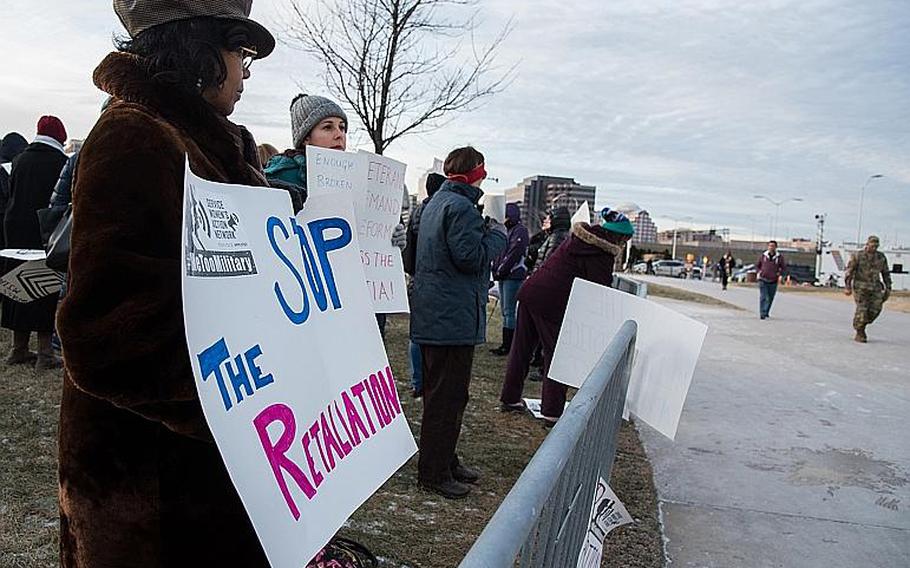 Demonstrators hold signs denouncing sexual harassment and assault in the military outside the Pentagon Monday, Jan. 8, 2018 as Defense Department workers enter the building. The #metoomilitary Stand Down event was organized by the Service Women's Action Network.