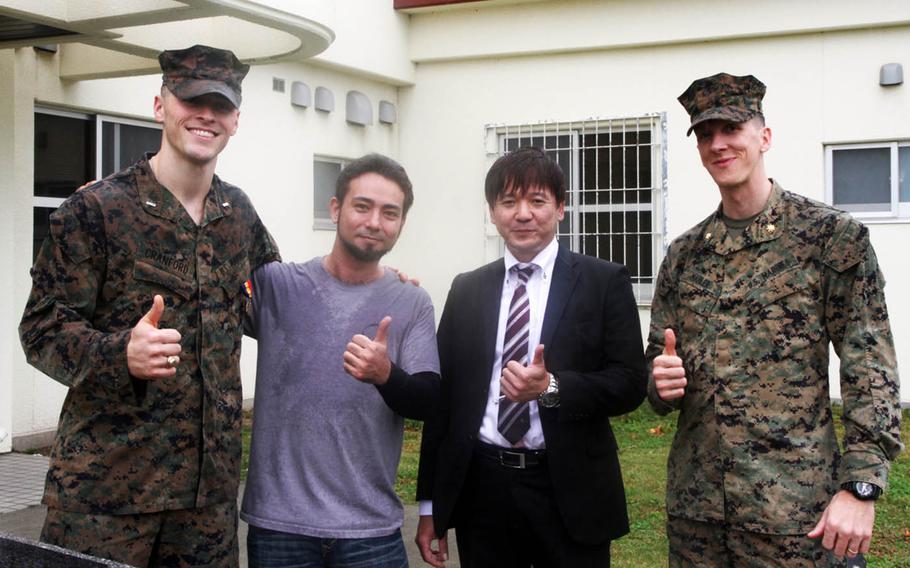 From left to right, Marine 1st Lt. Aaron Cranford, Justin Kinjo, Yusuke Teruya and Maj. John Mahler pose at Camp Schwab, Okinawa, after Cranford received the Navy and Marine Corps Medal, Monday, Jan. 8, 2017. Cranford saved Kinjo, Teruya and two others from drowning in April 2017.