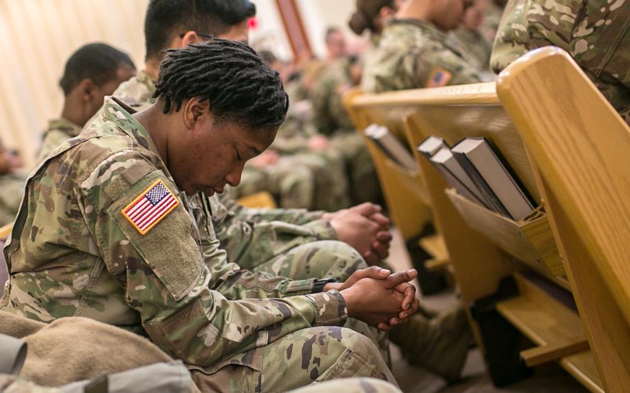 A soldiers grieve during a memorial service for Staff Sgt. Kyle LeFlore at Camp Humphreys, South Korea, Thursday, Jan. 11, 2018.