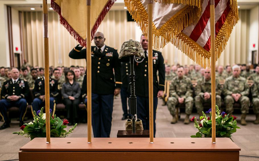 Chief Warrant Officer 2 Daniel Robinson, left, and Sgt. Ryan McChesney salute the soldier cross representing Staff Sgt. Kyle LeFlore at Camp Humphreys, South Korea, Thursday, Jan. 11, 2018.