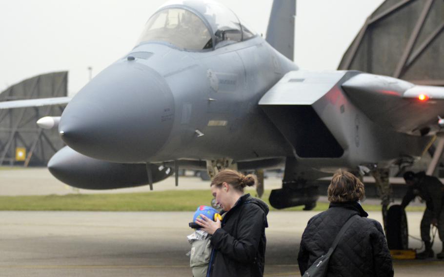 Family wait for Capt. "Nacho" Taylor to get out of an F-15C Eagle shortly after returning to RAF Lakenheath, England, from a NATO Baltic air-policing rotation at Siauliai Air Base in Lithuania, Tuesday, Jan. 9, 2018.