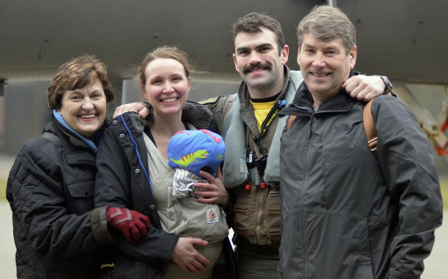 Capt. "Nacho" Taylor poses with his family after landing at RAF Lakenheath, England, from a deployment to Siauliai Air Base, Lithuania, Tuesday, Jan. 9, 2018.