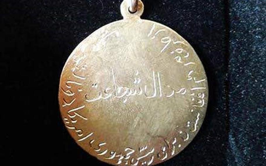 Pictured here in an undated photo is a $650 gold medal for bravery that a community in Logar province, Afghanistan, presented to the U.S. Embassy in Kabul on behalf of President Donald Trump on Saturday, Jan. 13, 2018.