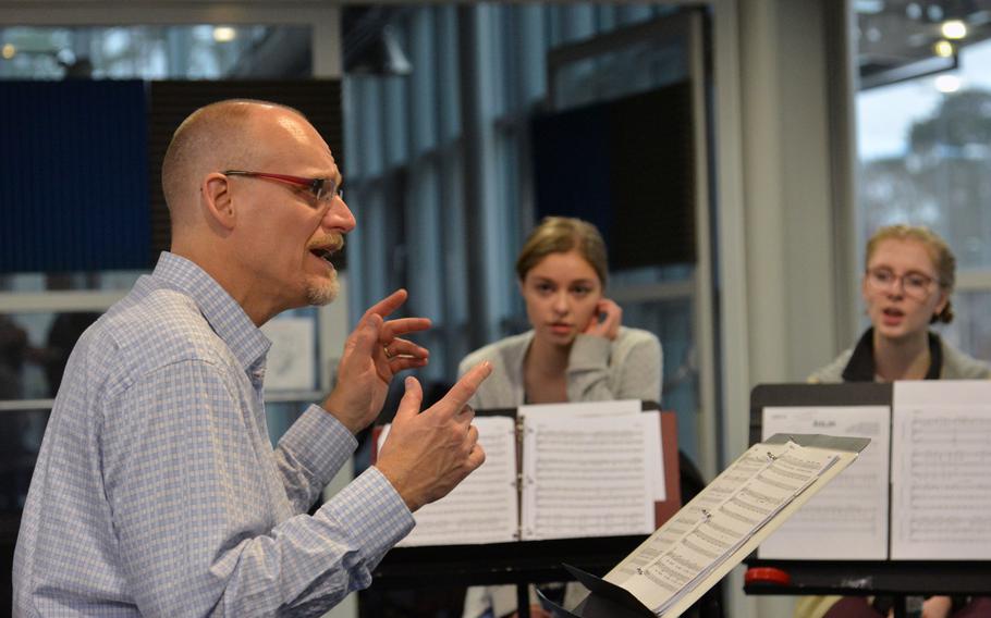 Conductor Darmon Meader goes over a song with the vocalists at DODEA-Europe jazz seminar in Ramstein, Germany, Tuesday, Jan. 16, 2018. Listening are Stuttgart's Aubrey Armstrong and Vilseck's Violet Bender, right.