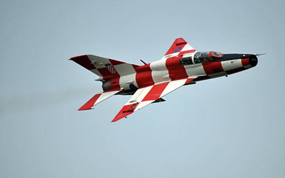 A Croatian MiG-21UM twin-seat trainer in flight. Painted in Croatia's checkerboard red-and-white pattern, the plane is one of less than a dozen MiG-21s that remain operational in Europe today.