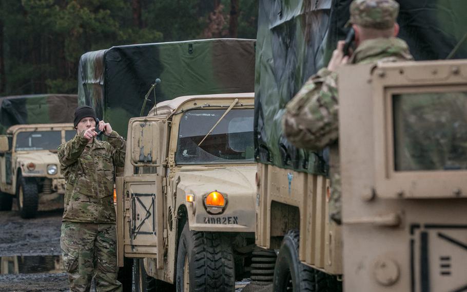 Spc. Caleb L. Gardner, left, an intelligence analyst assigned to Delta Company, 82nd Brigade Engineer Battalion, 2nd Armored Brigade Combat Team, 1st Infantry Division, Fort Riley, Kan., conducts radio checks with other vehicles within a convoy at Zagan, Poland, Jan. 11, 2018.