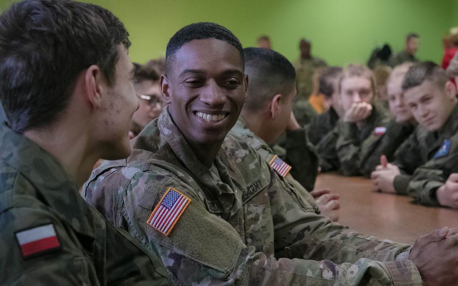 Sgt. Demetri R. Richardson, a wheeled vehicle mechanic from 2nd Armored Brigade Combat Team, 1st Infantry Division, Fort Riley, Kansas, answers questions about his life as an American Soldier from Polish high school cadets, Jan 15, 2018 at a school in Rzepin, Poland.