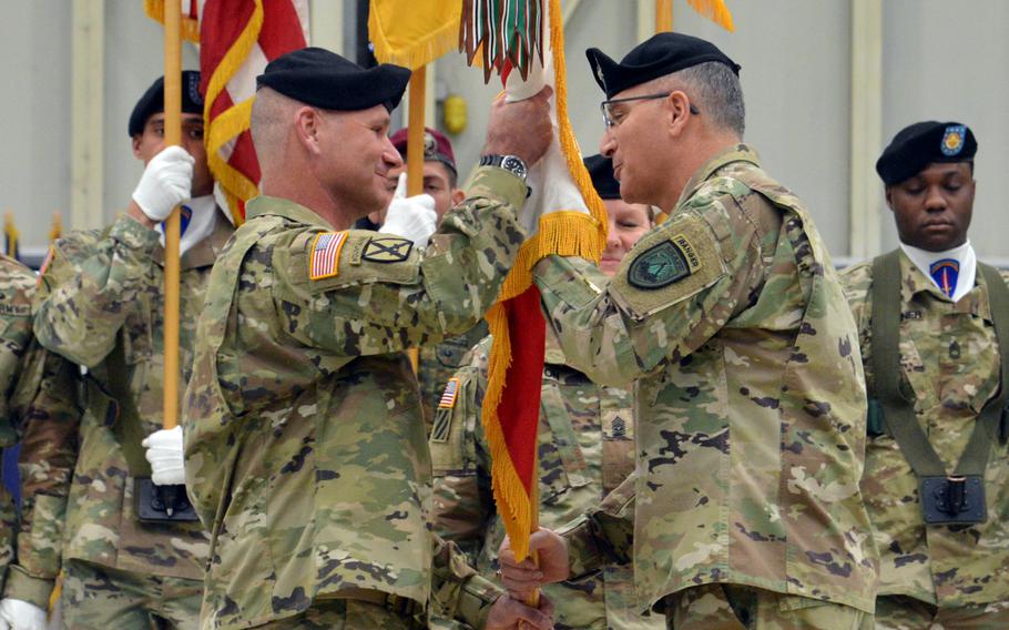 Lt. Gen. Christopher Cavoli, left, takes the U.S. Army Europe colors from Gen. Curtis Scaparrotti, commander of U.S. European Command, at Cavoli's assumption-of-command ceremony at Clay Kaserne in Wiesbaden, Germany, Thursday, Jan. 18, 2018.
