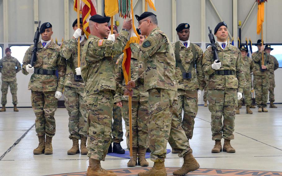 Lt. Gen. Christopher Cavoli, left, takes the U.S. Army Europe colors from Gen. Curtis Scaparrotti, commander of U.S. European Command at Cavoli's assumption-of-command ceremony at Clay Kaserne in Wiesbaden, Germany, Thursday, Jan. 18, 2018.