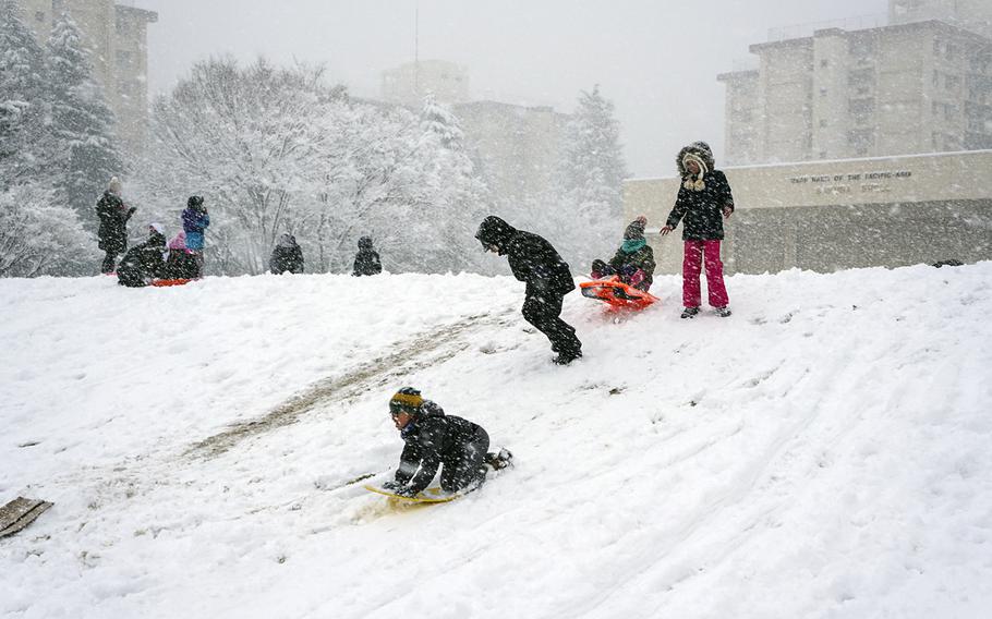Children at Yokota Air Base play in the snow, which caused early closures at Camp Zama, Naval Air Facility Atsugi and Yokota on Jan. 22, 2018.