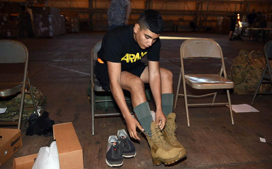 A soldier with the 25th Infantry Division in Hawaii pulls on a prototype of a jungle combat boot earlier this month. Soldiers will test the new boot and a hot-weather uniform for the next half-year in jungle conditions in Hawaii and Southeast Asia.