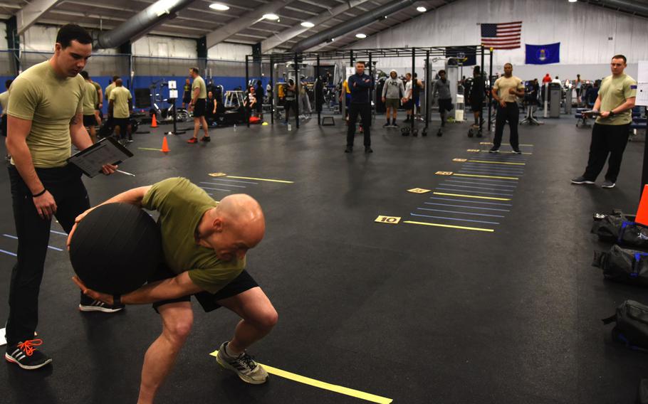 Senior Master Sgt. Kenneth Blakeney, second from left, launches a medicine ball at the fitness center at Joint Base Andrews, Md., Tuesday, Jan. 9, 2018. The Air Force began the introduction of Tier 2 physical training standards as more than 100 battlefield Airmen demonstrated new career-field-specific testing components.
