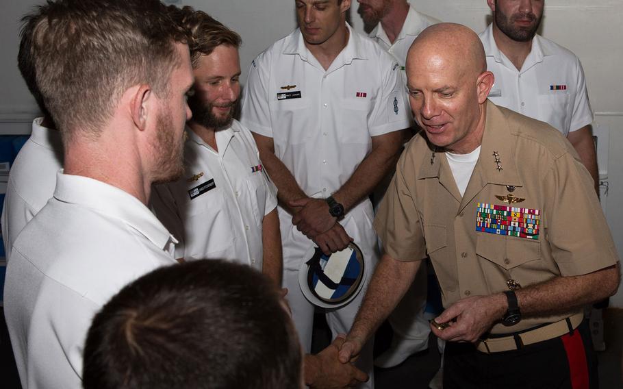 Lt. Gen. David Berger, Marine Forces Pacific commander, speaks with members of Australian Clearance Diving Team One after presenting a U.S. Meritorious Unit Commendation aboard the HMAS Adelaide in Sydney, Monday, Jan. 29, 2018.