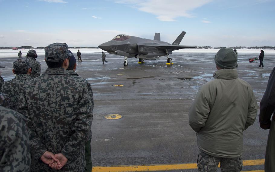 Japan Air Self-Defense Force members join 35th Fighter Wing and Naval Air Facility-Misawa leadership to watch Japan's first F-35A arrive at Misawa Air Base, Friday, Jan. 26, 2018.