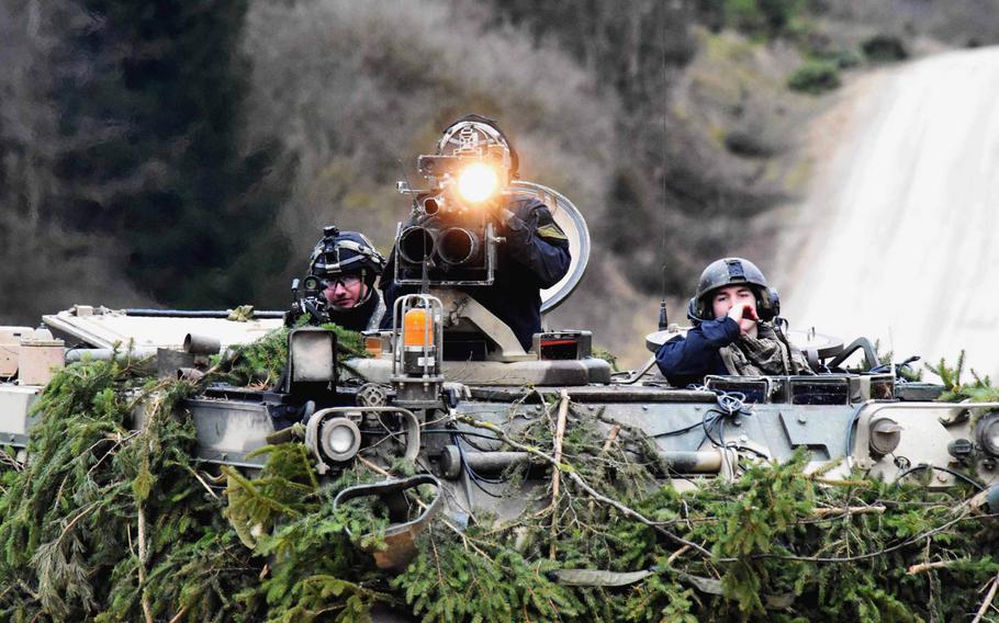 The enemy forces, in a training scenerio, signal to fellow soldiers using a spotlight, during the Allied Spirit VIII exercise in Hohenfels, Germany, Monday, Jan. 29, 2018.