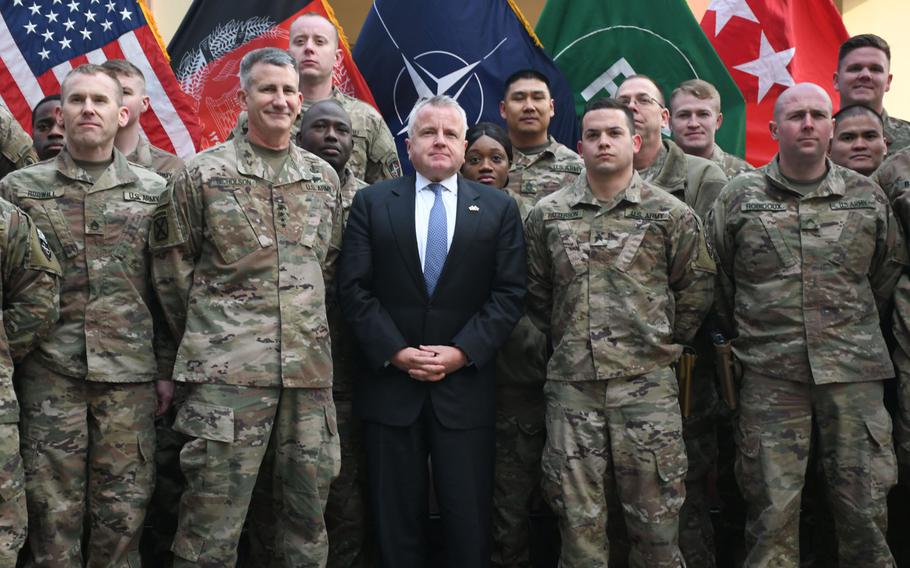 Deputy Secretary of State John J. Sullivan, center, and John Nicholson, the U.S.'s top commander in Afghanistan, left, pose with U.S. troops at NATO's Resolute Support headquarters in Kabul on Tuesday, Jan. 30, 2018.
