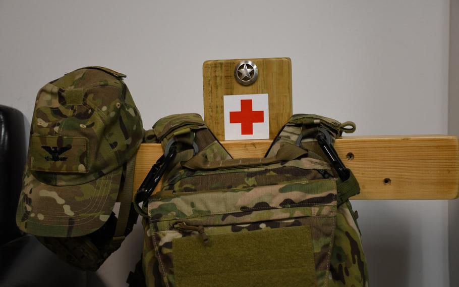 Pictured here on Monday, Jan. 29, 2018, equipment belonging to Col. Walter "Sparky" Matthews hangs on a post decorated with one of the small Texas Ranger badges he hands out to staff at the hospital at Bagram Air Field, Afghanistan.