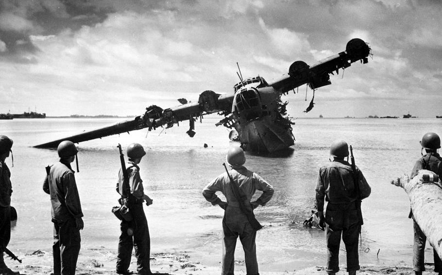 Soldiers examine a wrecked Japanese Kawanishi H8K near Makin, Gilbert Islands in November 1943. Two similar planes were used in a bombing raid on Oahu, Hawaii, on March 4, 1942.