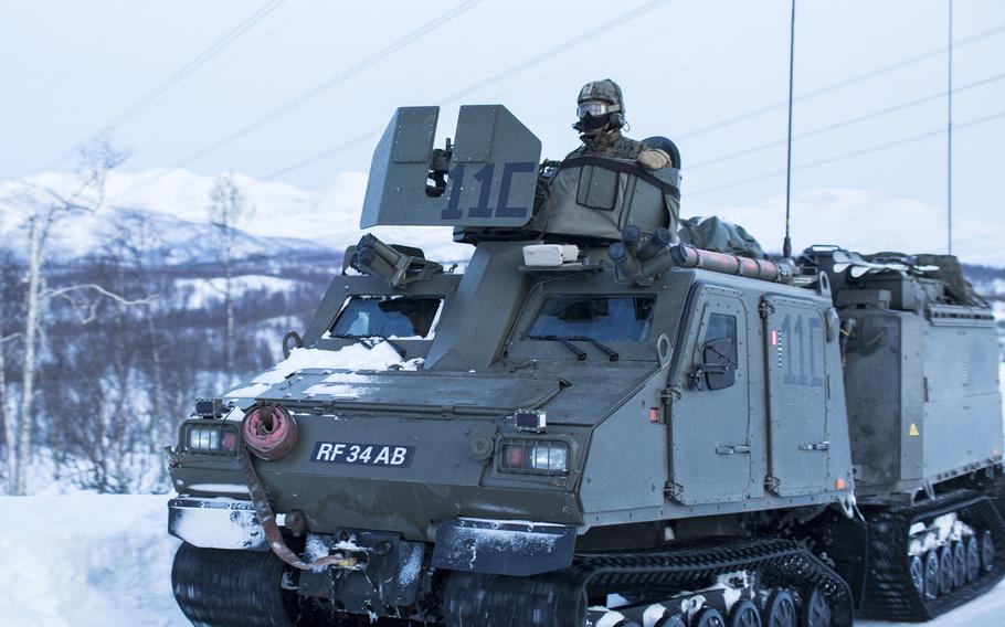 Marines use a Viking belted vehicle (BvS10) to insert a squad for a mountainous assault on enemy position during exercise White Claymore near Bardufoss, Norway, Feb. 15, 2018.