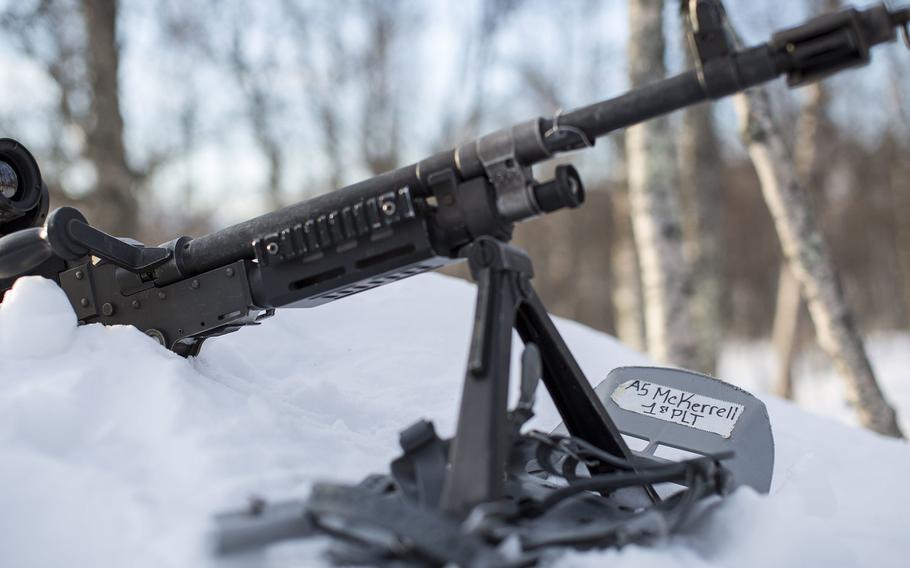 A Marine uses his snowshoes to support his M240B machine gun as he stands a security post during exercise White Claymore near Bardufoss, Norway, Feb. 15, 2018.