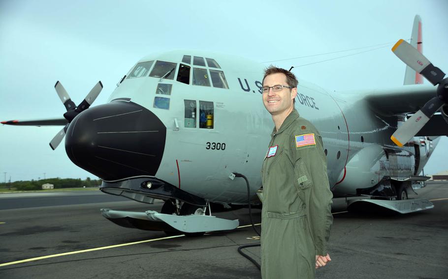 Maj. Malcolm Schongalla of the New York Air National Guard's 109th Airlift Wing poses at Joint Base Pearl Harbor-Hickam, Hawaii, beside the LC-130 he piloted in Antarctic, Feb. 28, 2018.