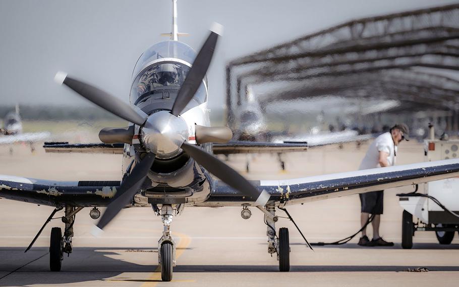 A communications crew chief monitors components for a T-6 Texan II training aircraft last summer at Vance Air Force Base, Okla.