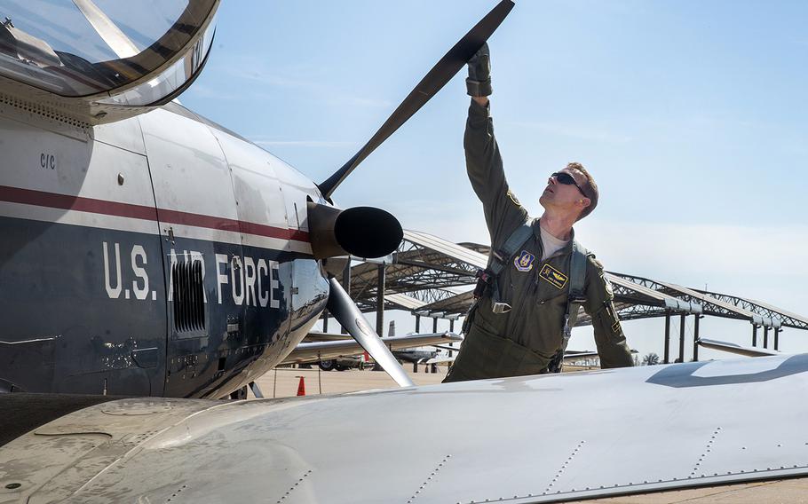 Maj. Chris Robinson, 5th Flying Training Squadron instructor pilot, inspects the propeller on a T-6 Texan II before a flight last November at Vance Air Force Base, Okla.