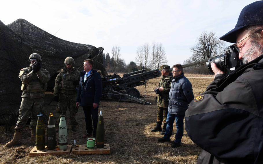 U.S. Army representatives show German mayors and community leaders different types of artillery rounds during exercise Dynamic Front, at Grafenwoehr, Germany, Monday, March 5, 2018. 