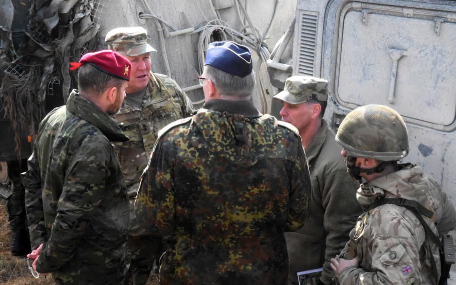 Maj. Gen. Timothy McGuire, deputy commanding general of U.S. Army Europe, speaks with German and British soldiers during Exercise Dynamic Front 18 at Grafenwoehr, Germany on Wednesday, March 7, 2018.