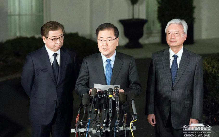 South Korean National Security Adviser Chung Eui-yong, flanked by National Intelligence Service chief Suh Hoon, left, and ambassador to the United States Cho Yoon-je, right, speaks to reporters outside the White House, Thursday, March 8, 2018.