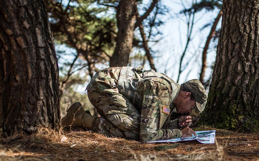 Sgt. William Stallworth of 176th Financial Management Support Unit, 498th Combat Support Sustainment Battalion plots points for land navigation during the 19th Expeditionary Command best-warrior competition, Tuesday, March 6, 2018.