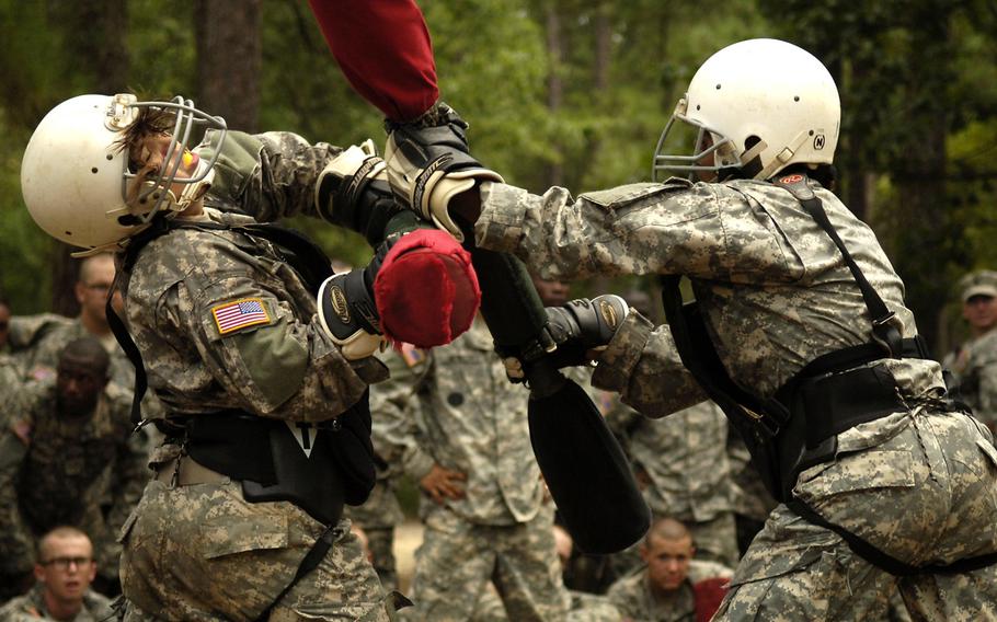 Army trainees practice hand-to-hand combat using pugil sticks during basic combat training at Fort Jackson, S.C.  A new study found that unit cohesion was unaffected by adding women