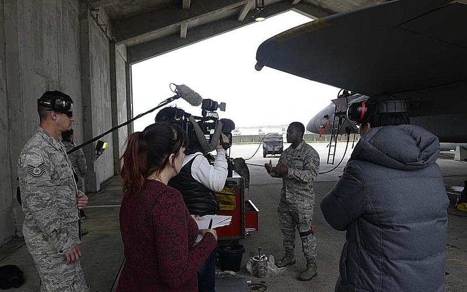 Air Force Staff Sgt. Johnny Brown, 18th Aircraft Maintenance Squadron dedicated crew chief, explains F-15 Eagle maintenance to local media members Feb.14, 2018, at Kadena Air Base, Japan. The Air Force is now restricting media access while it retrains its public affairs teams.
