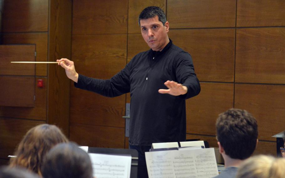 Guest conductor Damon Talley leads the band through a number at the DODEA-Europe Honors Music Festival, Tuesday, March 13, 2018.