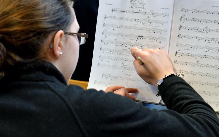 Marianna Szukala, a clarinetist from Alconbury High School, makes some changes to her notes as she and the band rehearse at this year's DODEA-Europe Honors Music Festival, Tuesday, March 13, 2018.