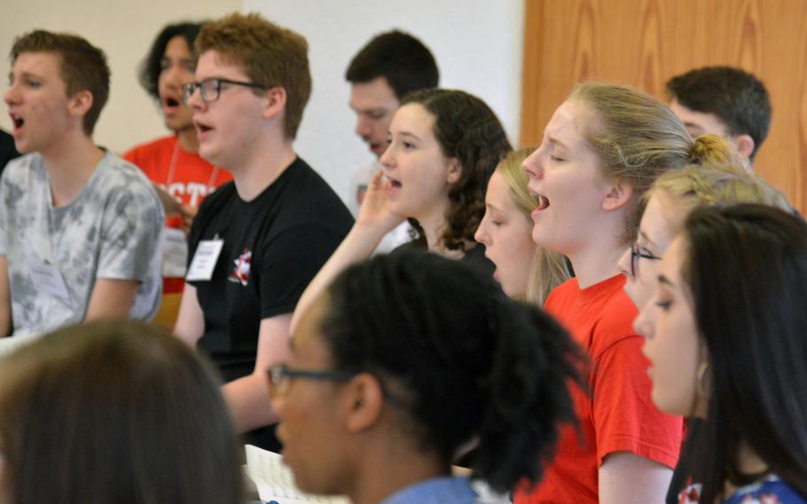 Members of the choir go through a number at the DODEA-Europe Honors Music Festival, Tuesday, March 13, 2018.