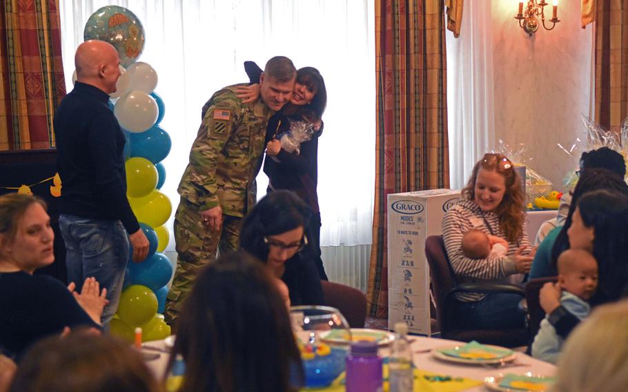 Col. Lance. Varney gets a suprise hug from Heidi Murkoff, author of the What to Expect series, at the Special Delivery baby shower event, at Grafenwoehr, Germany, Wednesday, March 14, 2018.