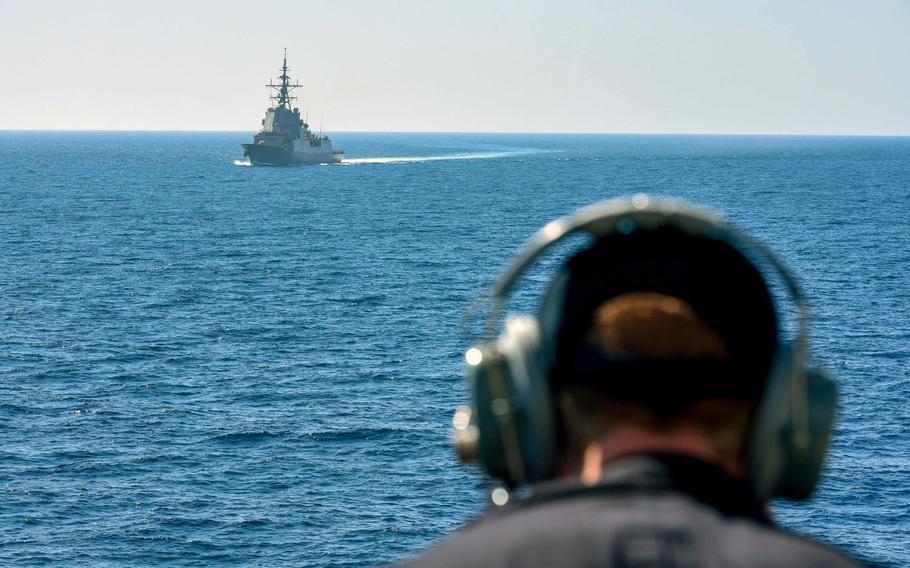 Seaman Jon Adams watches the Spanish frigate ESPS Cristobal Colon accompany the Arleigh Burke-class guided-missile destroyer USS Laboon during exercise  Dynamic Manta 2018, March 11 in the Mediterranean Sea.
