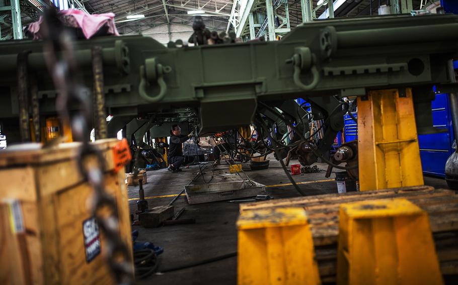 Workers at the Heavy Equipment Division reconstruct a truck bed at Camp Carroll, South Korea, Tuesday, March 6, 2018.