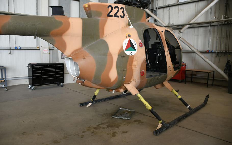 An MD-530 helicopter sits in a hangar at Hamid Karzai International Airport in Kabul on Tuesday, March 6, 2018, after being damaged by small arms fire in February.