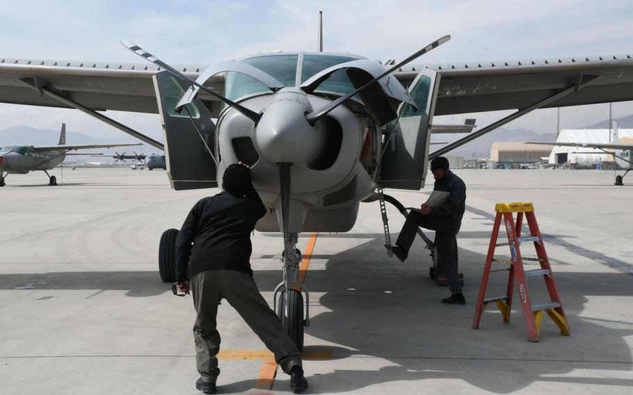 Afghan maintainers perform a post-operating inspection on a Cessna 208 Caravan at Hamid Karzai International Airport in Kabul on Tuesday, March 6, 2018.