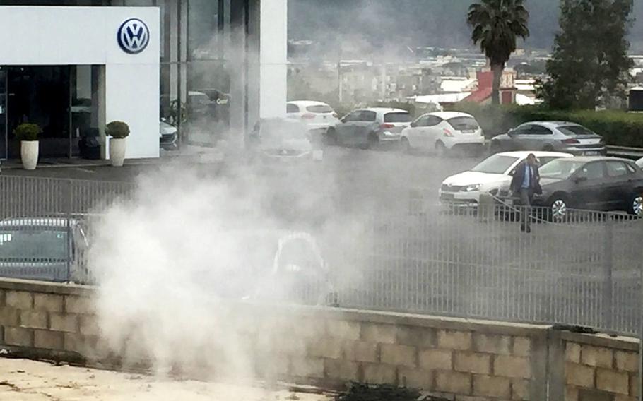 One of Campi Flegrei's sulphurous craters emits steam at a Volkswagen dealership in Pozzuoli, Italy, on March 6, 2018. Researchers say the underground supervolcano, which covers 90 square miles, has become more active and unpredictable and could erupt in the future.
