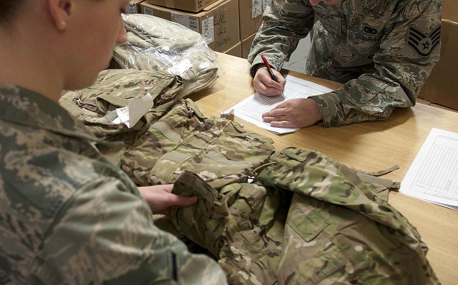 An airman inspects "Multicam" uniforms at F.E. Warren Air Force Base, Wyo., in 2015.