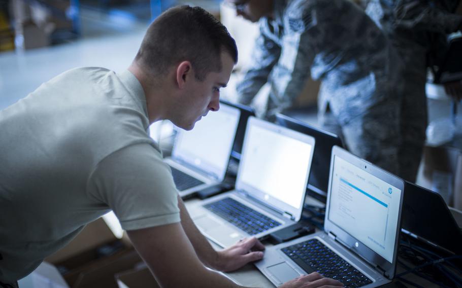 Senior Airman Zach Wilt, 49th Communications Squadron cyber operator, installs Microsoft Windows 10 to a laptop at Holloman Air Force Base, N.M., Nov. 1, 2017.