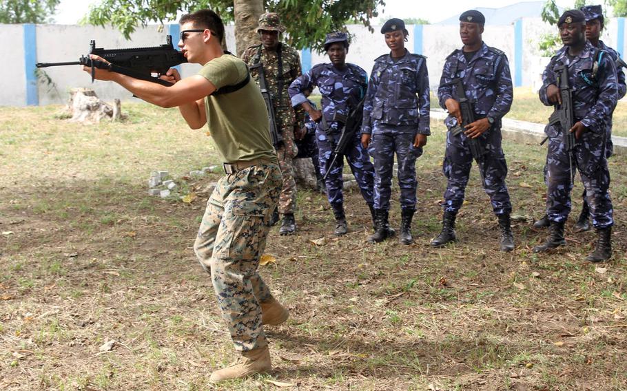 A U.S. Marine demonstrates an alert posture to members of the Ghanaian Revenue Authority Customs Division and Ghana Immigration Services during weapons handling instruction in Kpetoe, Ghana, March 22, 2017. The U.S. wants to update its status of forces agreement with Ghana, but there are no plans to establish an American-run military base there, U.S. officials said.