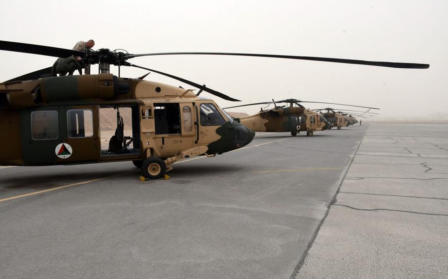 Some of Afghanistan's 11 UH-60 Back Hawks sit at Kandahar Air Filed, grounded by bad weather on Sunday, March 18, 2018.