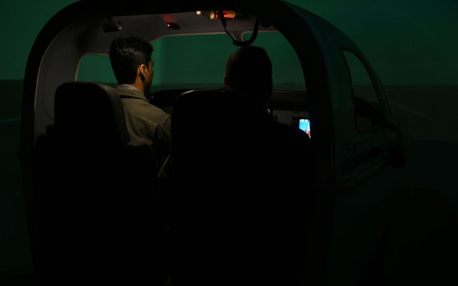 Afghan C208 pilot Capt. Naween, left, trains on an aircraft simulator at Hamid Karzai International Airport on Saturday, March 17, 2018. The U.S. is pushing the Afghans to become more proficient on the American-made aircraft as their Russian helicopters become unsustainable.