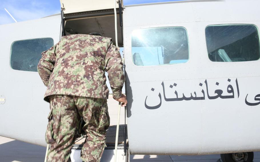 An Afghan servicemember enters an Afghan air force Cessna 208 Caravan at Kandahar Air Filed on Saturday, March 17, 2018.