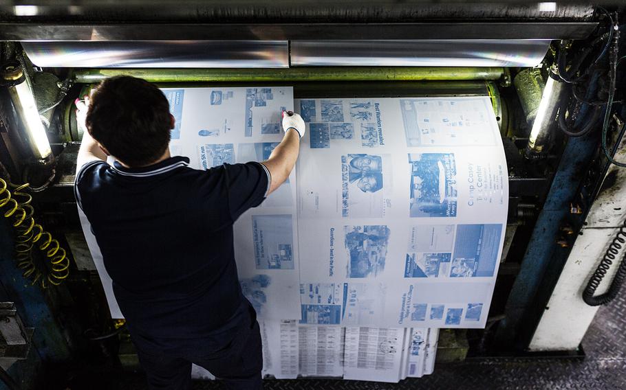 Morning Calm newspaper plates are placed onto a printing press in Bucheon, South Korea, Wednesday, March 21, 2018.