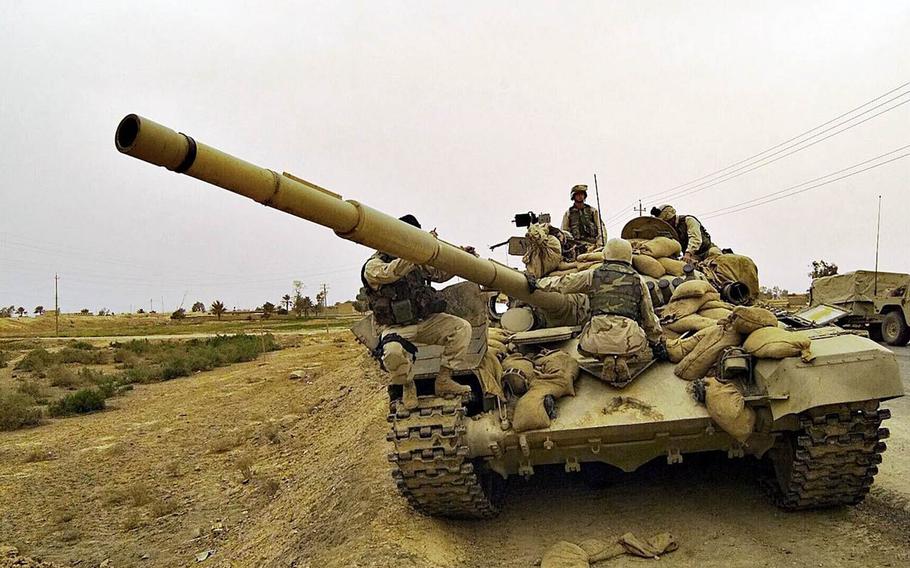 Marines taking part in Operation Iraqi Freedom find an abandoned T-72 tank in a suburb of Baghdad, April 8, 2003.